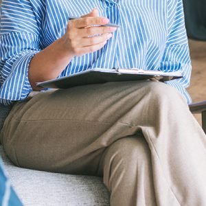 Professional Psychotherapy. Female Psychologist Having Session With Male Patient At Mental Health Clinic, Taking Note During Appointment In Office. Psychological Help Service. Treatment Of Depression